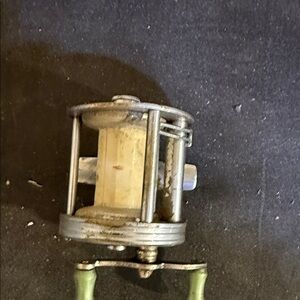 Vintage Fishing Reel with Green Accents​